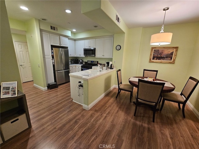 13435 Cascade Ct, Cerritos, CA 90703 - kitchen with a peninsula, appliances with stainless steel finishes, visible vents, and baseboards