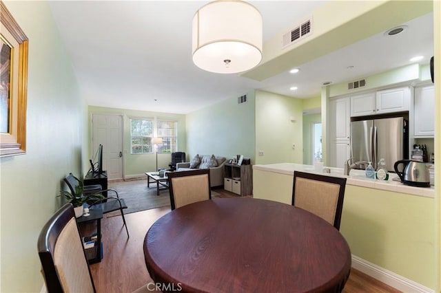 13435 Cascade Ct, Cerritos, CA 90703 - dining space with visible vents, wood finished floors, and baseboards