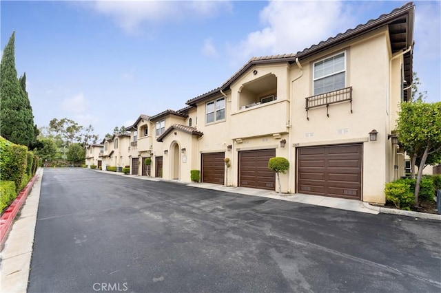 13435 Cascade Ct, Cerritos, CA 90703 - view of front of property featuring driveway, stucco siding, and a garage