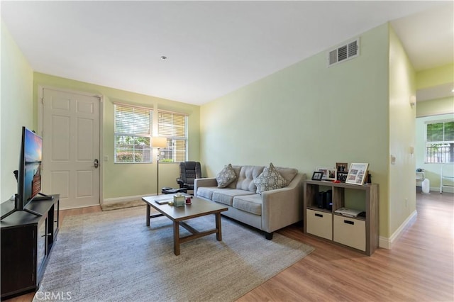 13435 Cascade Ct, Cerritos, CA 90703 - living room featuring baseboards, light wood-style floors, and visible vents