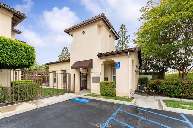 13435 Cascade Ct, Cerritos, CA 90703 - exterior space with stucco siding, a tile roof, fence, and uncovered parking