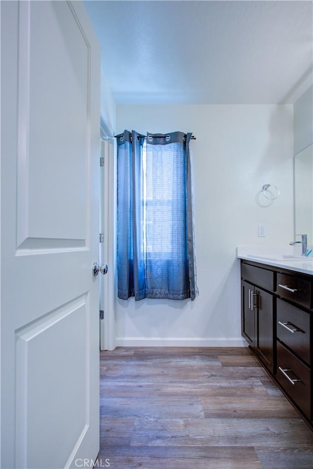 218 Bryce Canyon Ct, Merced, CA 95341 - bathroom featuring vanity, wood finished floors, and baseboards