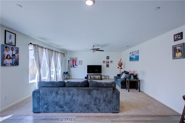 218 Bryce Canyon Ct, Merced, CA 95341 - carpeted living area featuring ceiling fan, wood finished floors, and baseboards