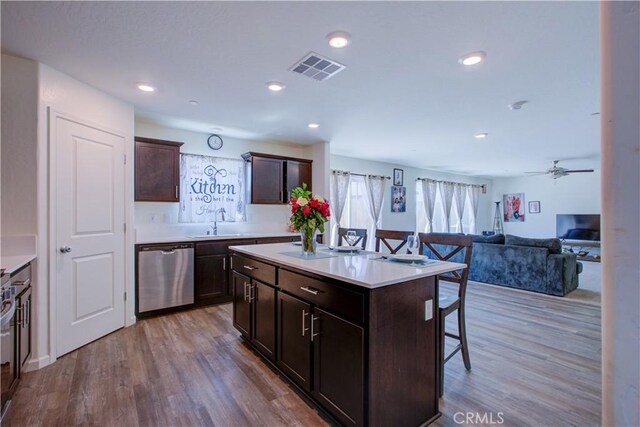 218 Bryce Canyon Ct, Merced, CA 95341 - kitchen with stainless steel dishwasher, a kitchen breakfast bar, a center island, wood finished floors, and recessed lighting