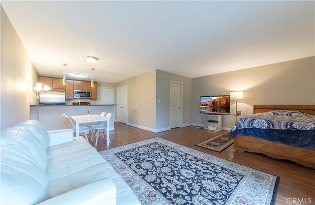 10982 Roebling Ave Unit 367, Los Angeles, CA 90024 - bedroom featuring fridge, wood finished floors, and baseboards