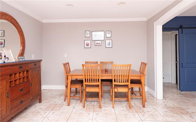 dining area featuring crown molding, baseboards, and light tile patterned floors