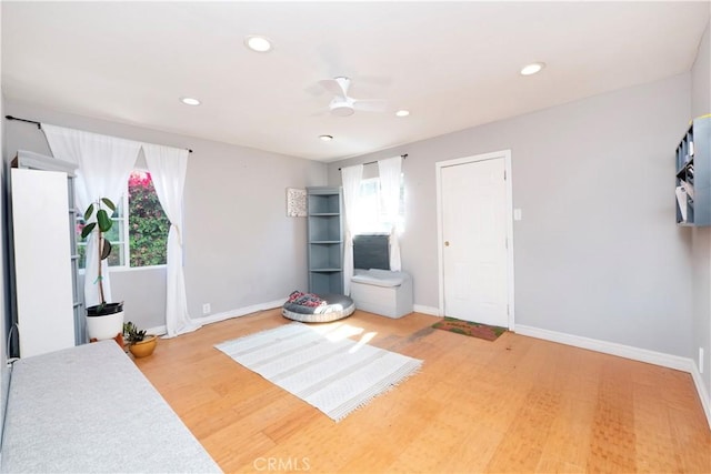 interior space featuring baseboards, a ceiling fan, light wood-style flooring, and recessed lighting