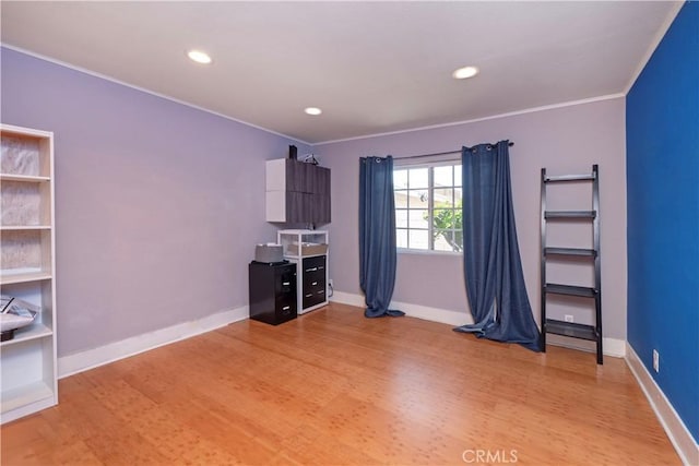 empty room featuring recessed lighting, baseboards, ornamental molding, and light wood-type flooring
