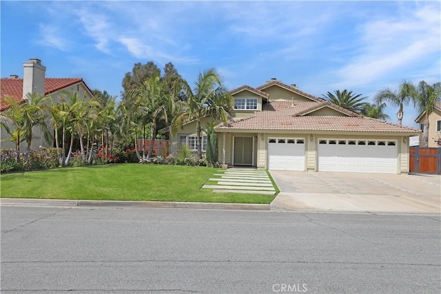 traditional-style home with an attached garage, a tile roof, fence, concrete driveway, and a front lawn