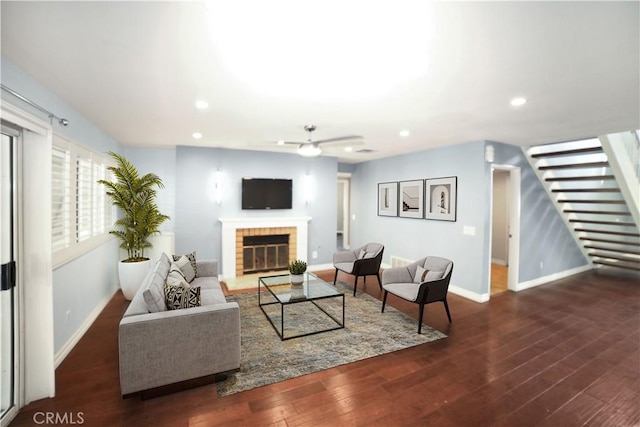 living room featuring recessed lighting, baseboards, ceiling fan, stairway, and a fireplace