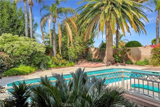 view of pool with a fenced in pool and fence