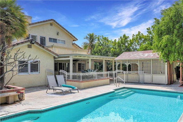 pool with a patio and fence