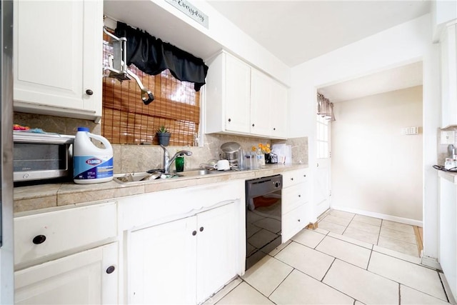 kitchen with a sink, white cabinets, backsplash, and black dishwasher