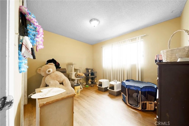 bedroom featuring a textured ceiling and wood finished floors