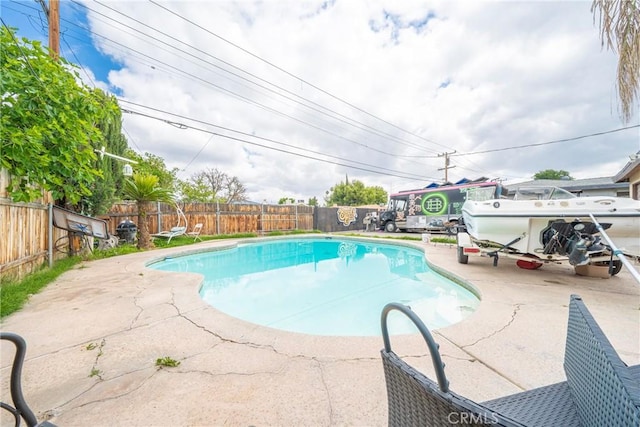 view of pool featuring a patio, a fenced in pool, and a fenced backyard