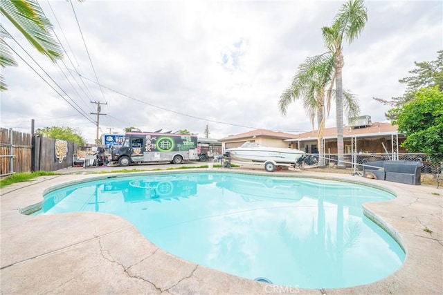 view of pool with a fenced in pool and fence