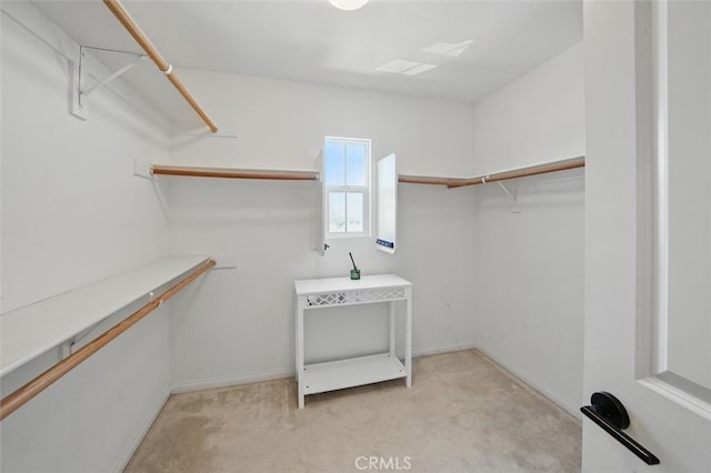 spacious closet with light colored carpet