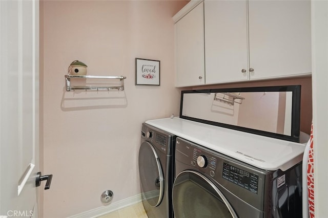 clothes washing area with baseboards, cabinet space, and independent washer and dryer