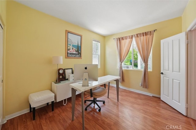 home office featuring baseboards and light wood-style flooring