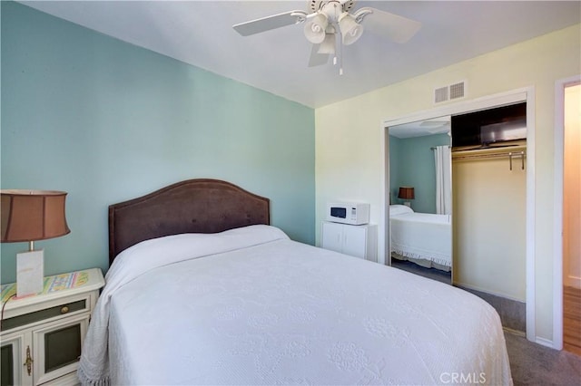 carpeted bedroom featuring a closet, a ceiling fan, and baseboards