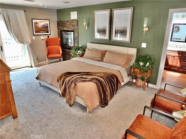 bedroom featuring visible vents, baseboards, connected bathroom, access to outside, and carpet