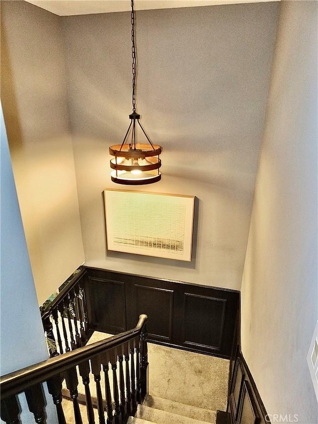 staircase featuring carpet flooring