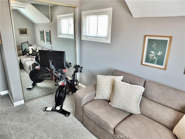 carpeted living room with baseboards