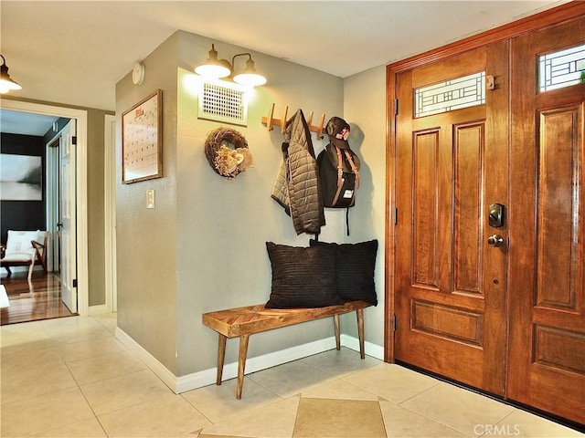 mudroom with light tile patterned floors, baseboards, and visible vents