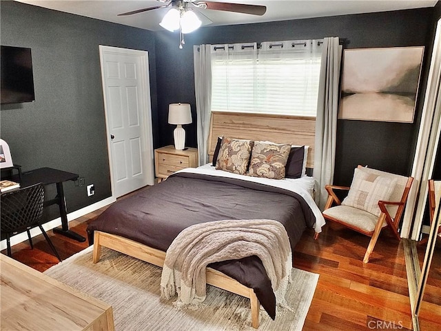 bedroom with a ceiling fan and wood finished floors