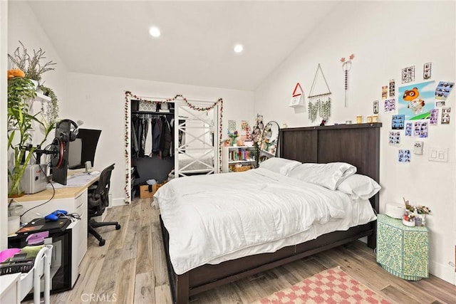 bedroom with baseboards, vaulted ceiling, recessed lighting, and light wood-style flooring