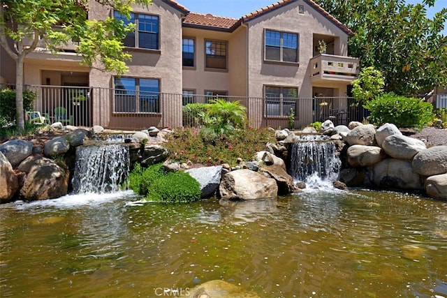 view of home's community with a small pond