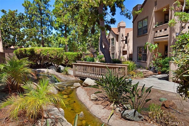 surrounding community with a garden pond