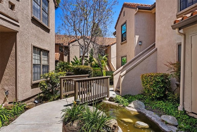 view of property's community with a garden pond