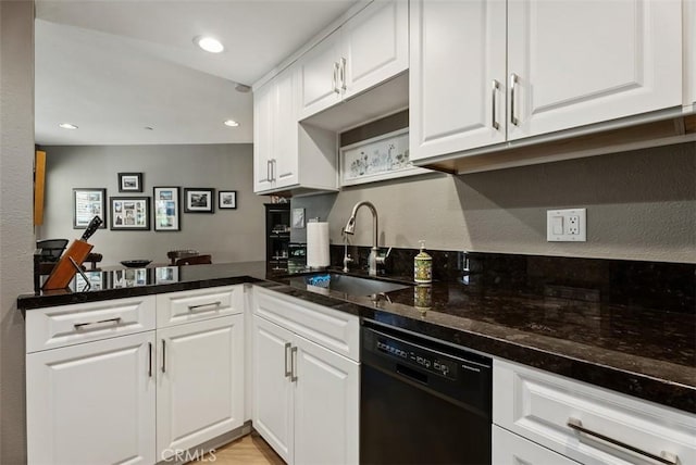 kitchen with a peninsula, recessed lighting, white cabinets, a sink, and dishwasher
