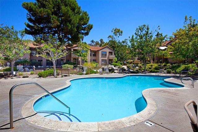 community pool with a patio area