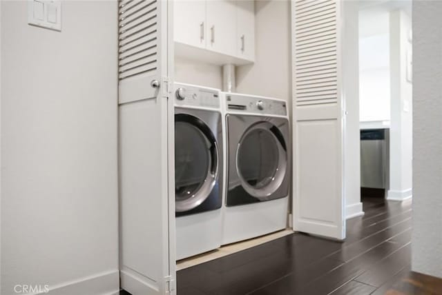 laundry room with baseboards, dark wood finished floors, and washing machine and clothes dryer