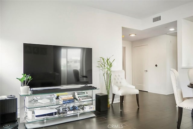 living area featuring recessed lighting, visible vents, and wood finished floors