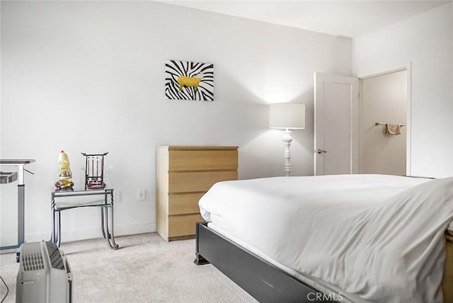 bedroom featuring baseboards and carpet flooring
