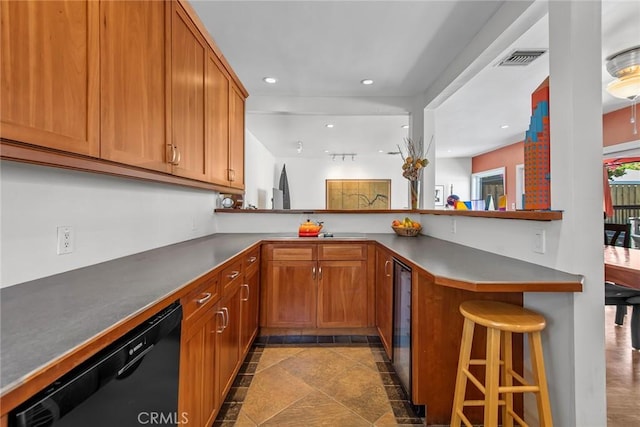 17557 Gilmore St, Lake Balboa, CA 91406 - kitchen with a kitchen breakfast bar, black dishwasher, recessed lighting, dark countertops, and brown cabinets