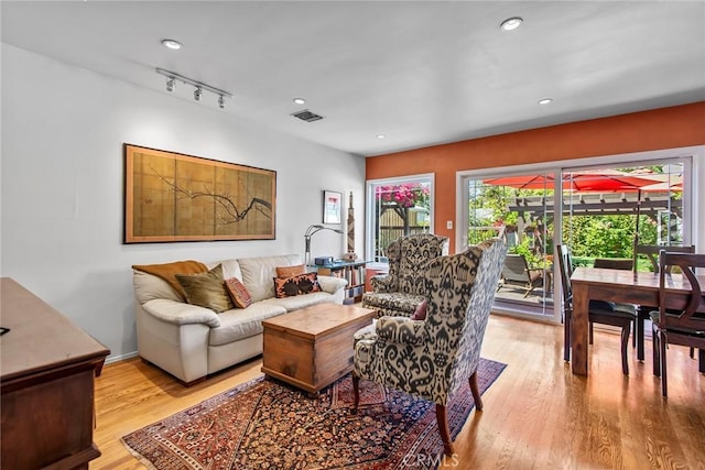 living room featuring recessed lighting, visible vents, and light wood-style floors