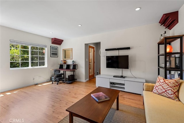 living area with recessed lighting, baseboards, and wood finished floors