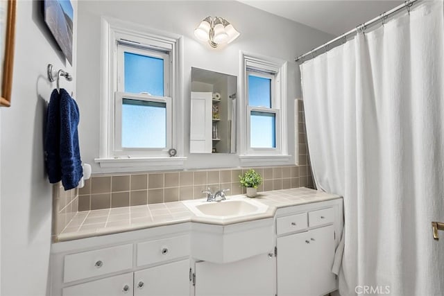 full bathroom featuring vanity and backsplash