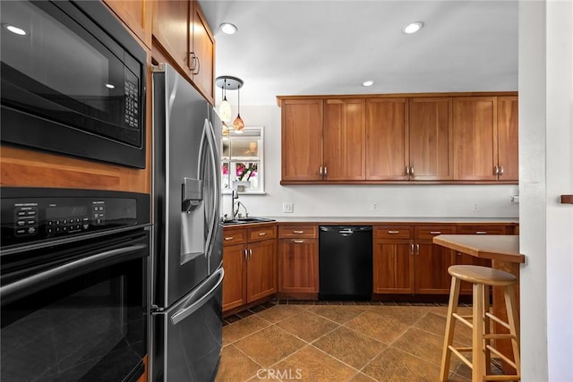 kitchen with brown cabinetry, recessed lighting, light countertops, a sink, and black appliances