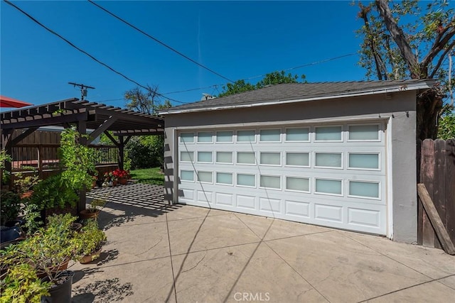 detached garage featuring fence