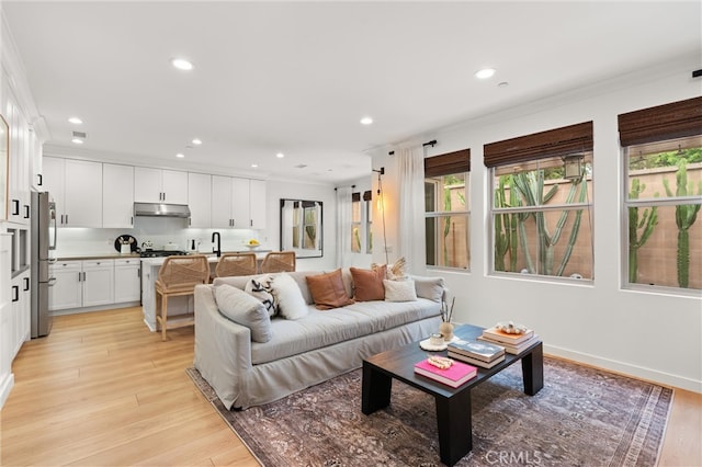 112 Gemstone, Irvine, CA 92620 - living room with recessed lighting, ornamental molding, and light wood finished floors