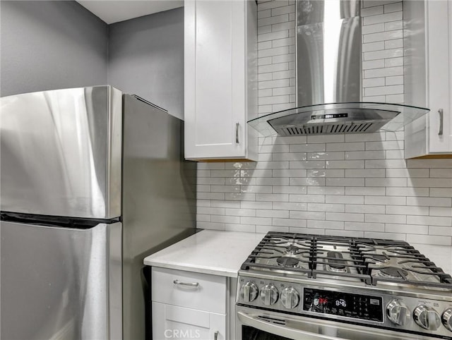 25081 Leucadia St Unit F, Laguna Niguel, CA 92677 - kitchen with wall chimney range hood, stainless steel appliances, tasteful backsplash, and white cabinetry