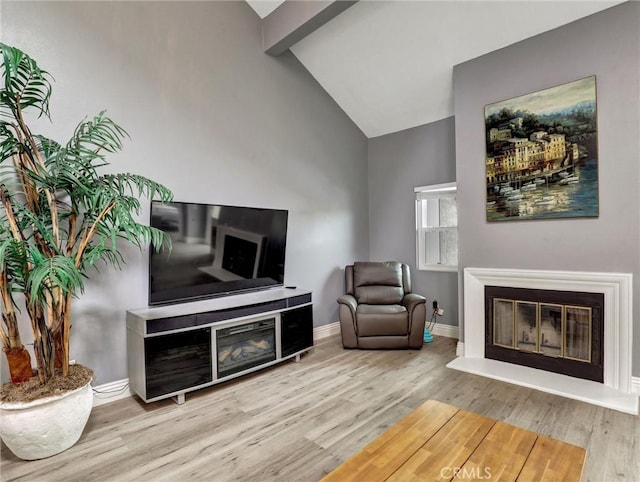 25081 Leucadia St Unit F, Laguna Niguel, CA 92677 - sitting room featuring a glass covered fireplace, wood finished floors, and baseboards