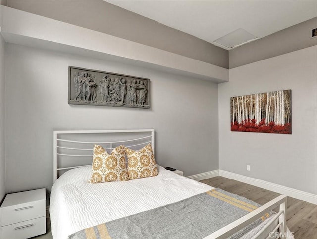 25081 Leucadia St Unit F, Laguna Niguel, CA 92677 - bedroom with wood finished floors, attic access, and baseboards