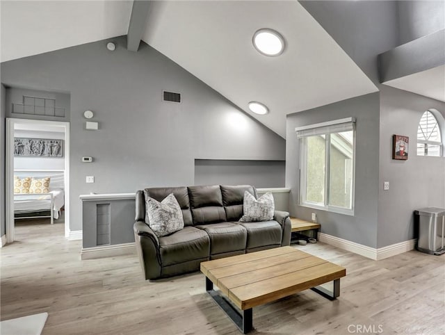 25081 Leucadia St Unit F, Laguna Niguel, CA 92677 - living room with light wood-type flooring, baseboards, beamed ceiling, healthy amount of natural light, and high vaulted ceiling