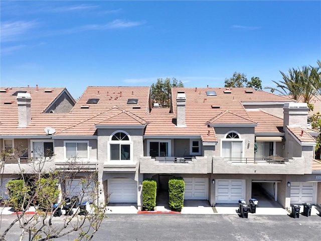 25081 Leucadia St Unit F, Laguna Niguel, CA 92677 - view of building exterior with a garage